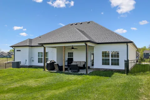 a view of a house with backyard and porch