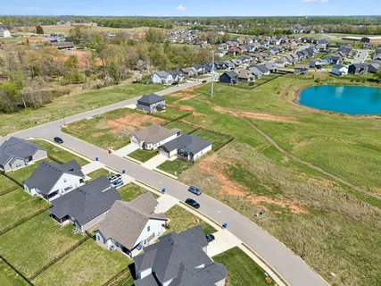 an aerial view of residential houses with outdoor space and river
