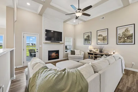 a living room with furniture a flat screen tv and a fireplace