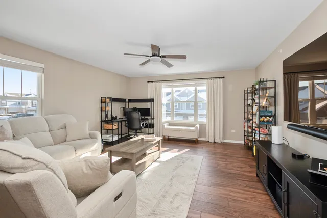 a living room with furniture a flat screen tv and a fireplace