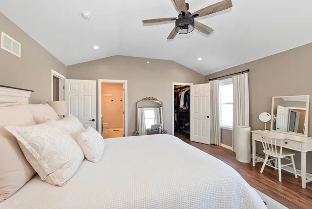 a bedroom with a large bed and a chandelier