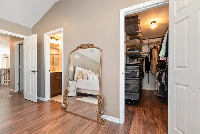 a view of a bedroom with wooden floor and closet