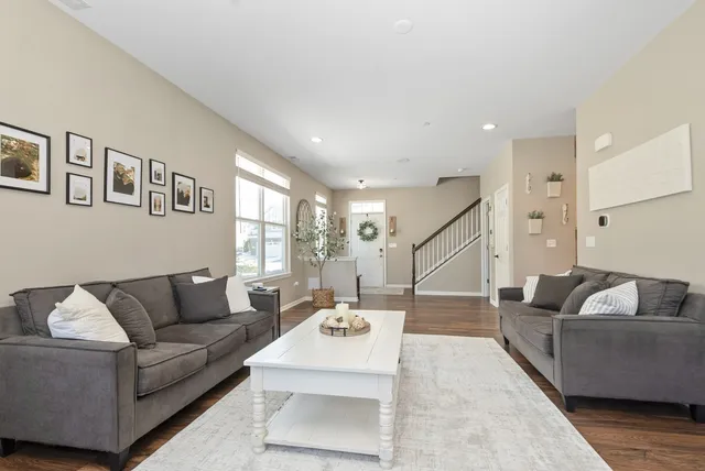 a living room with furniture and stairs