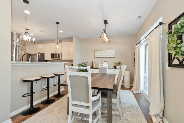 a view of a dining room with furniture and a chandelier