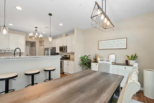 a large kitchen with a table and chairs