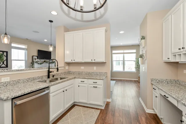a kitchen with sink cabinets and wooden floor