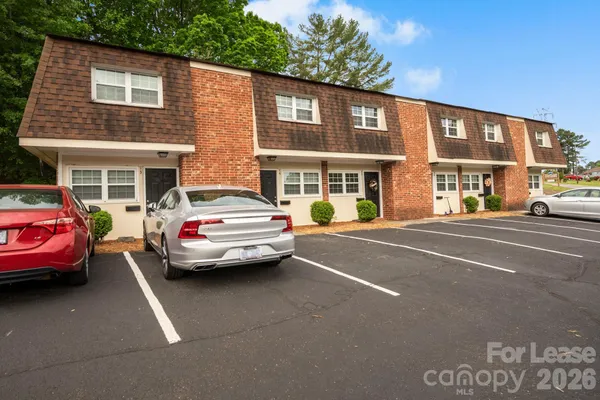a couple of cars parked in front of a building
