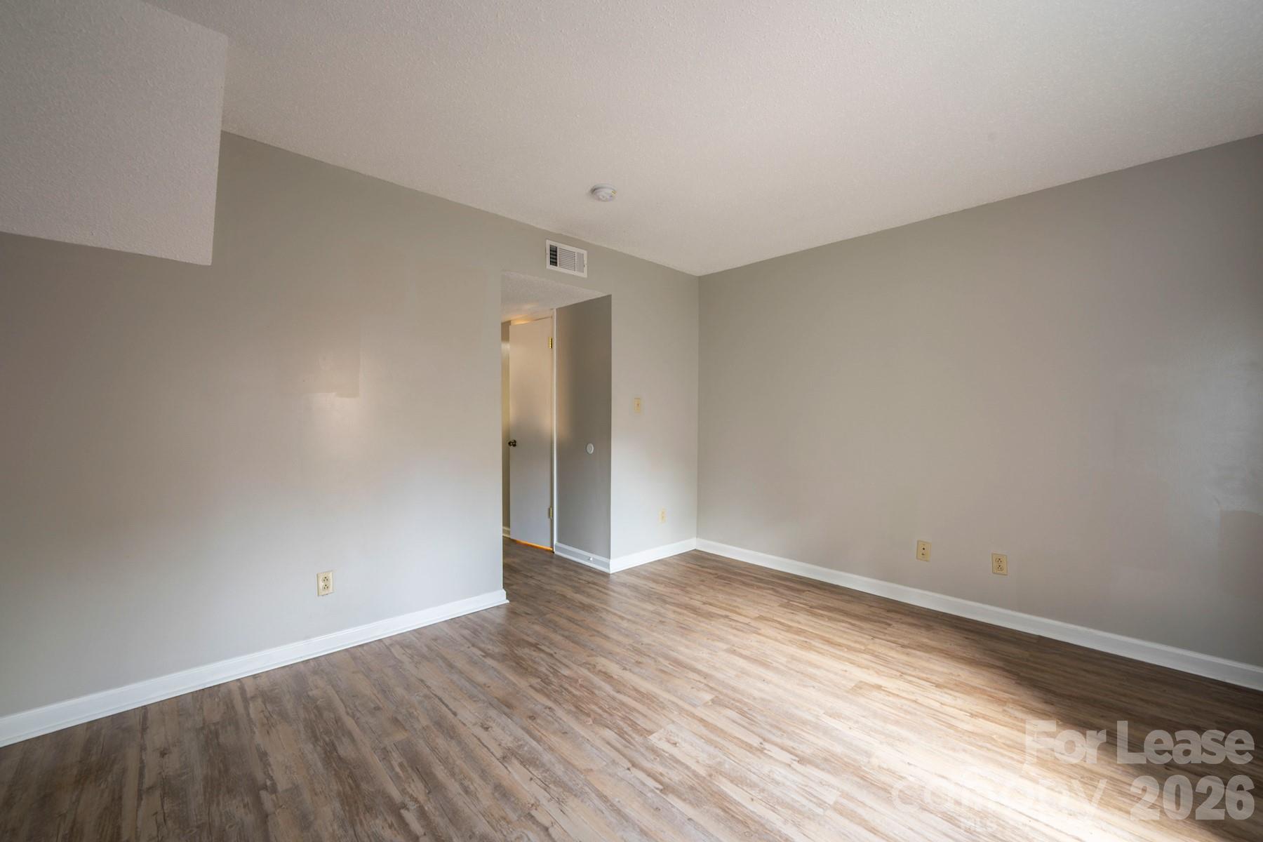 135 Ribet Avenue Southwest, Unit C12 Valdese, NC 28690 - Photo 11 of 19 a view of an empty room with wooden floor