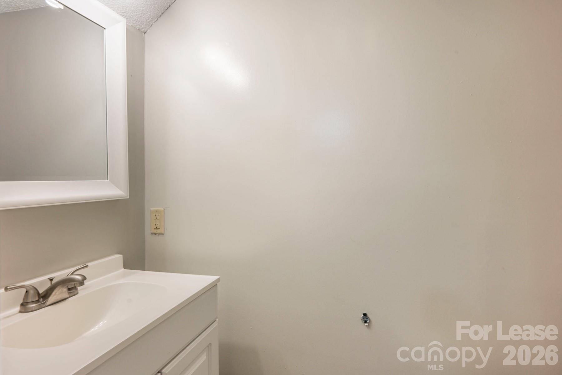 135 Ribet Avenue Southwest, Unit C12 Valdese, NC 28690 - Photo 12 of 19 a bathroom with a sink and a mirror