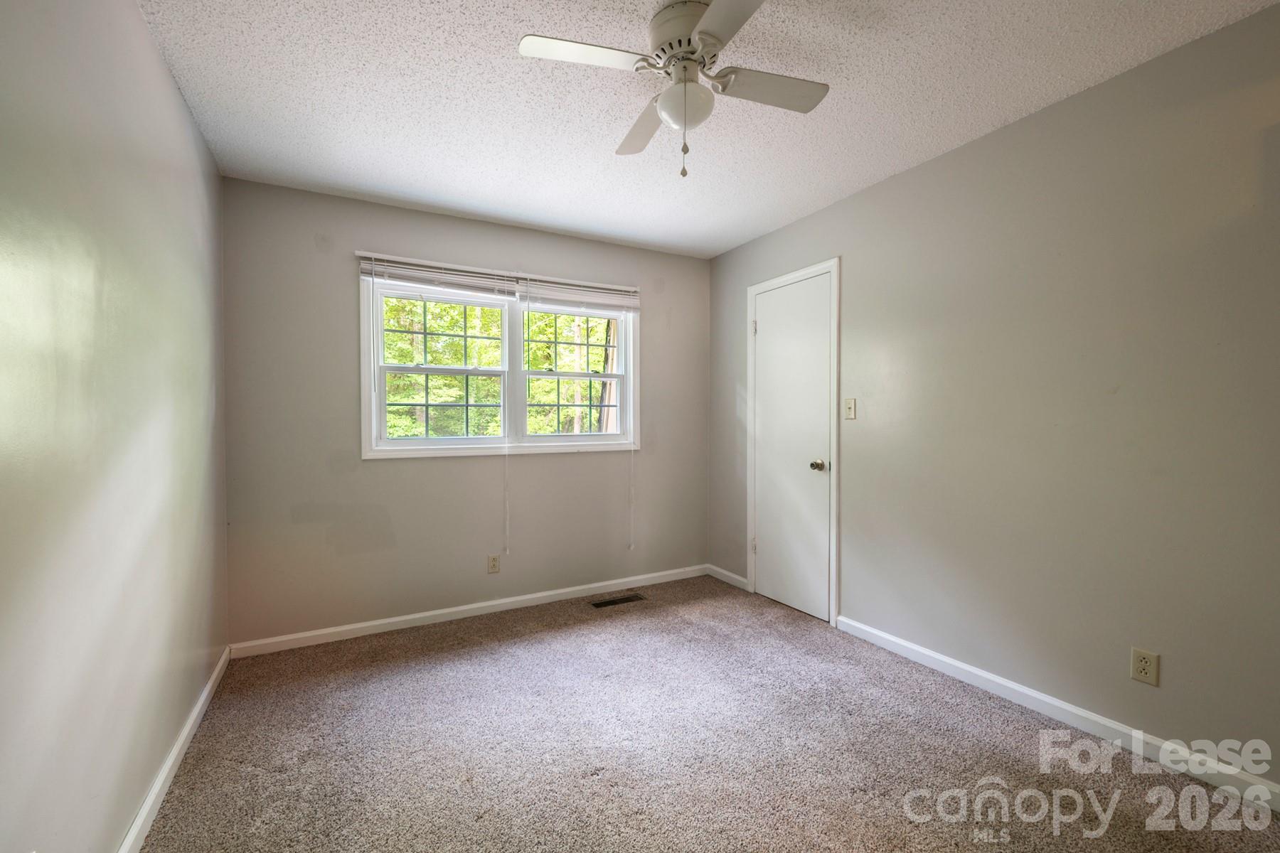 135 Ribet Avenue Southwest, Unit C12 Valdese, NC 28690 - Photo 14 of 19 an empty room with windows and fan