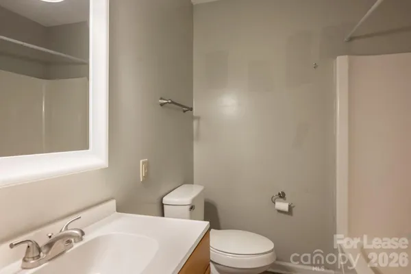 a white toilet sitting next to a bathroom sink