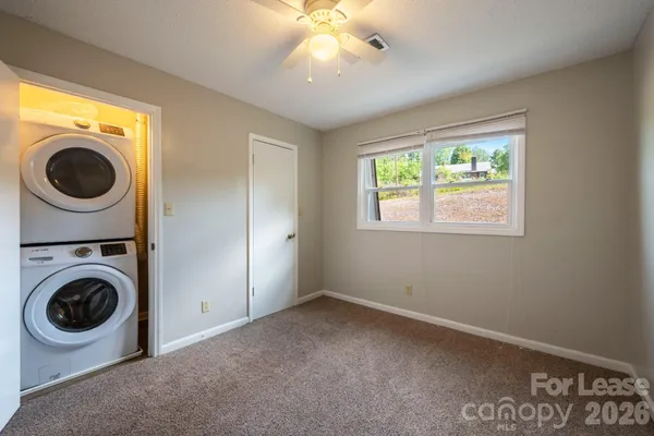 a view of a bedroom with washer and dryer