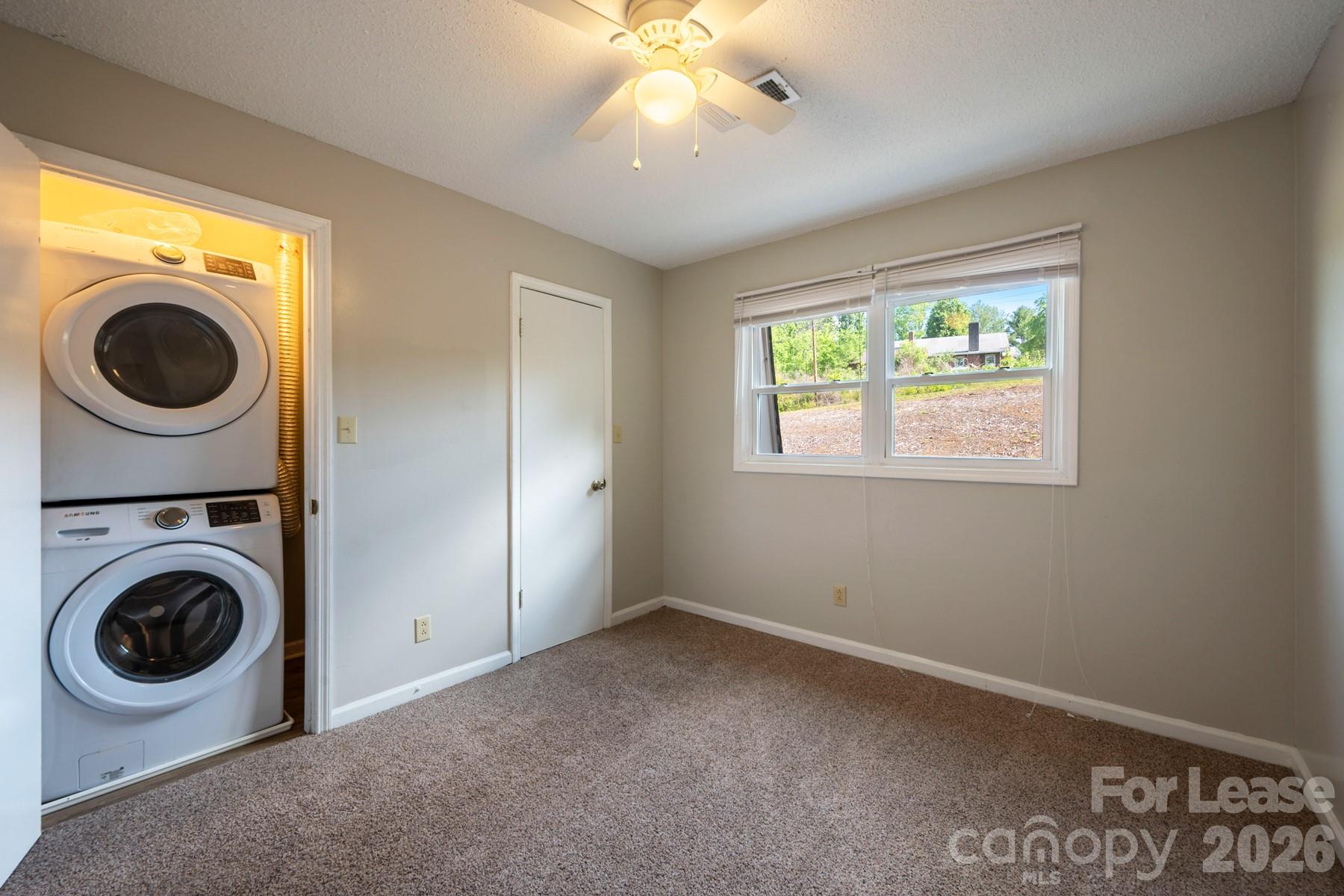 135 Ribet Avenue Southwest, Unit C12 Valdese, NC 28690 - Photo 18 of 19 a view of a bedroom with washer and dryer