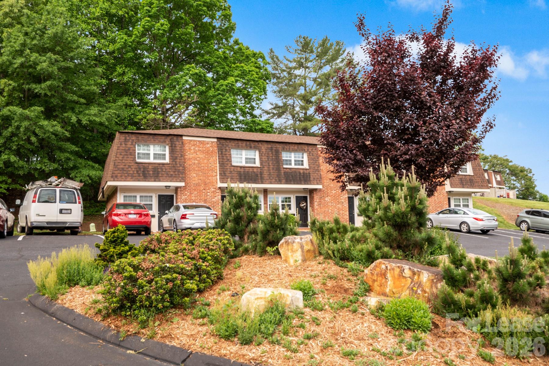 135 Ribet Avenue Southwest, Unit C12 Valdese, NC 28690 - Photo 4 of 19 a front view of a house with a yard and fountain