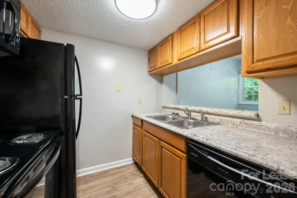 a kitchen with stainless steel appliances granite countertop a stove and a refrigerator