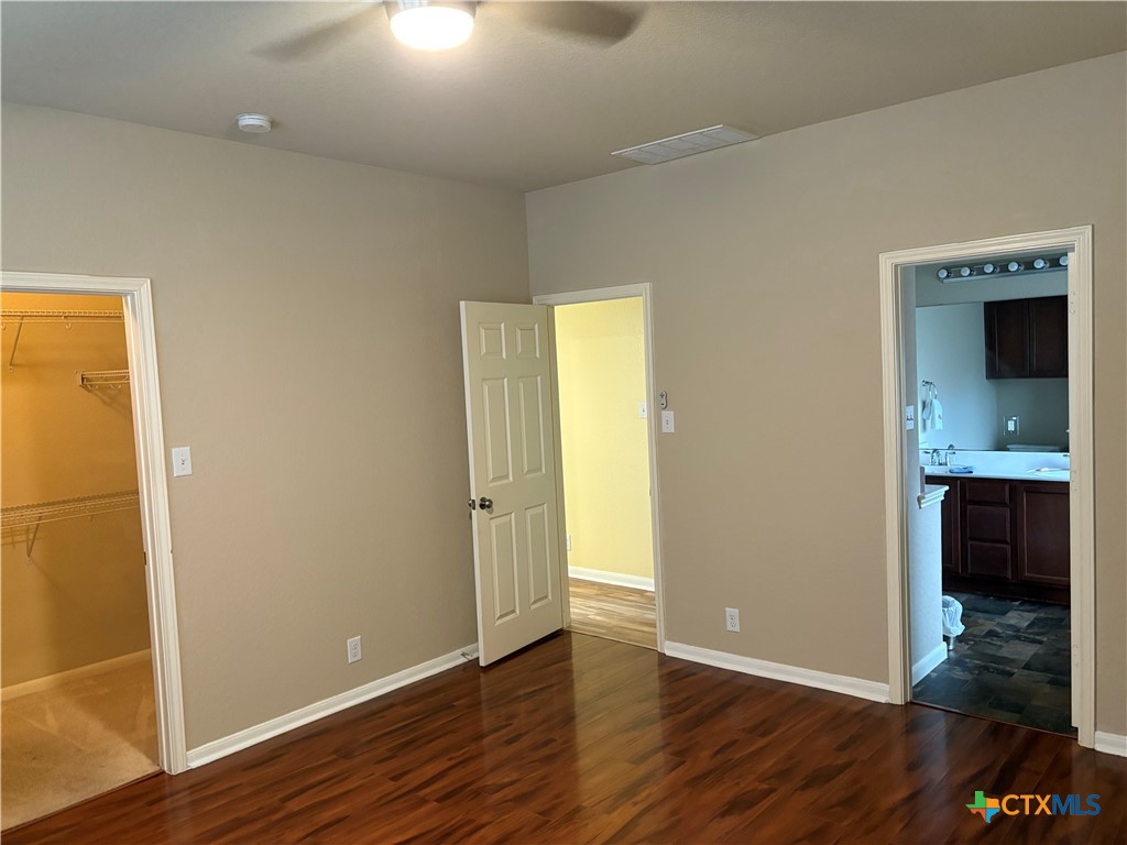 102 Wisteria Way San Marcos, TX 78666 - Photo 17 of 30 an empty room with wooden floor and cabinet