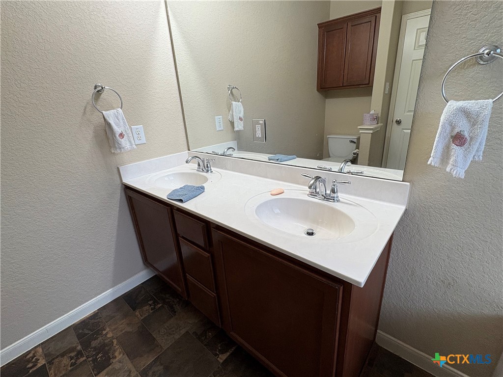 102 Wisteria Way San Marcos, TX 78666 - Photo 19 of 30 a bathroom with a sink and a mirror