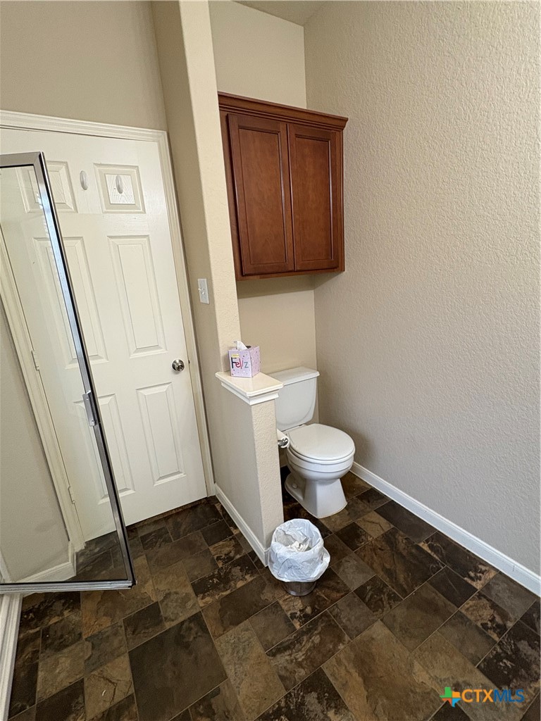 102 Wisteria Way San Marcos, TX 78666 - Photo 20 of 30 a bathroom with a toilet and a mirror