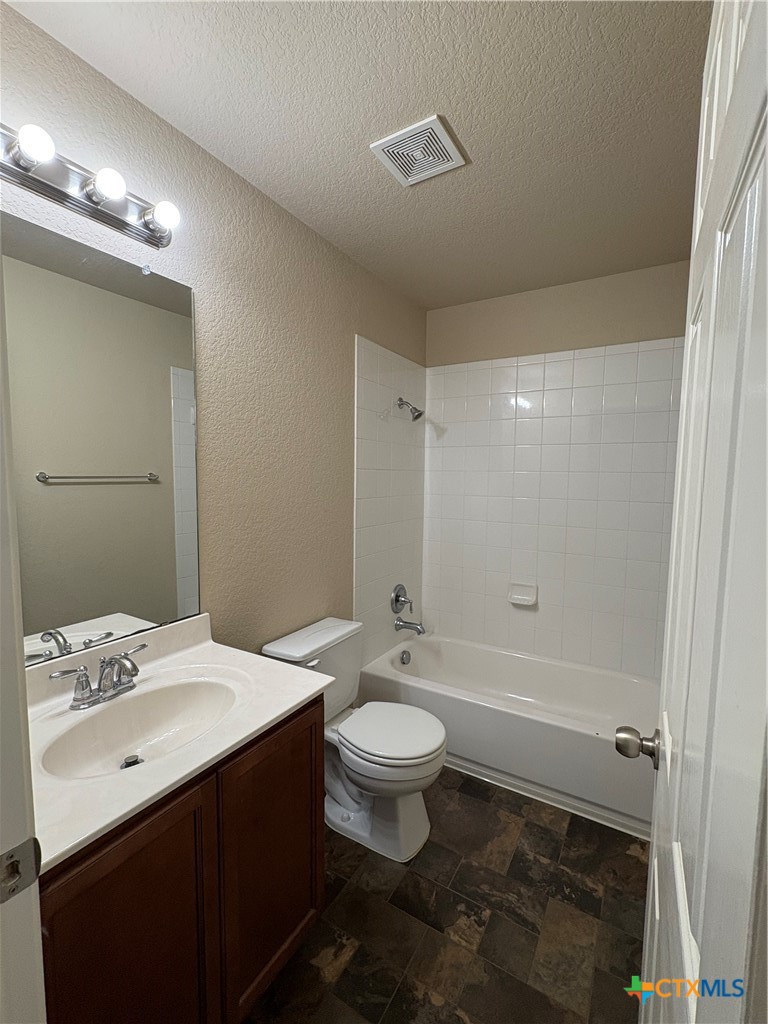 102 Wisteria Way San Marcos, TX 78666 - Photo 23 of 30 a bathroom with a double vanity sink toilet and shower