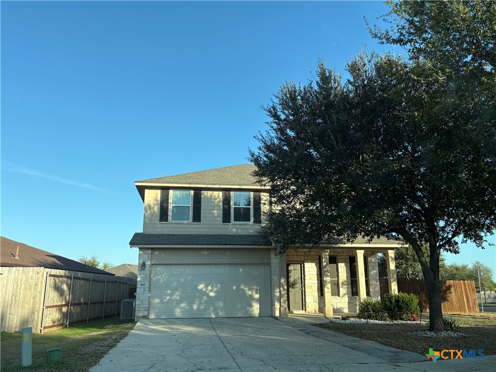 102 Wisteria Way San Marcos, TX 78666 - Photo 3 of 30 a front view of a house with a yard and garage