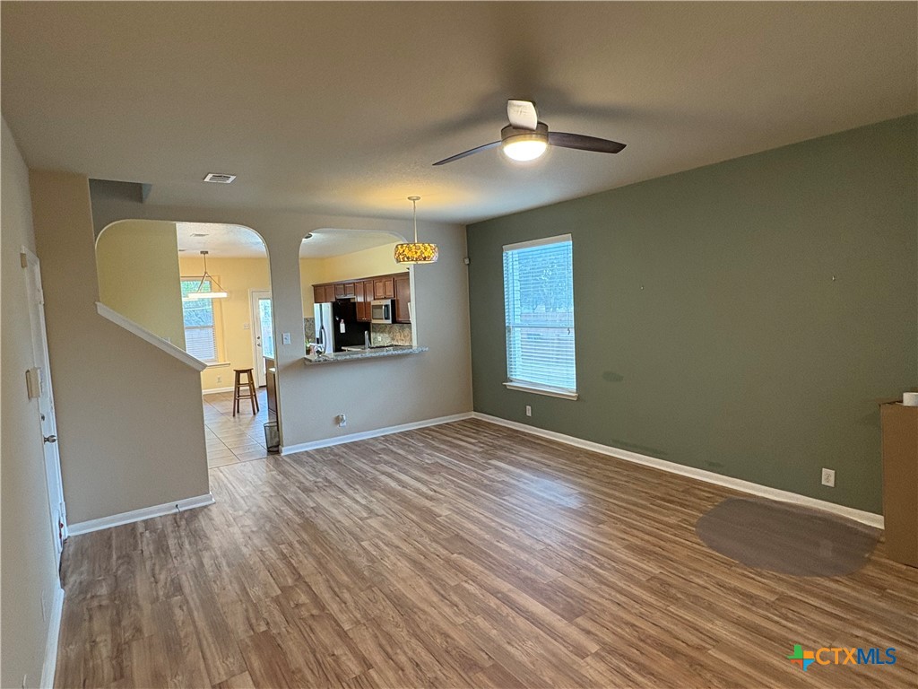 102 Wisteria Way San Marcos, TX 78666 - Photo 7 of 30 wooden floor in an empty room with a window