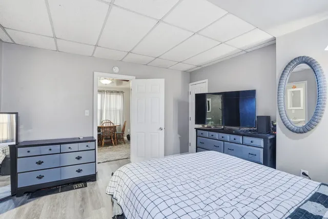 a bedroom with a bed and a flat screen tv