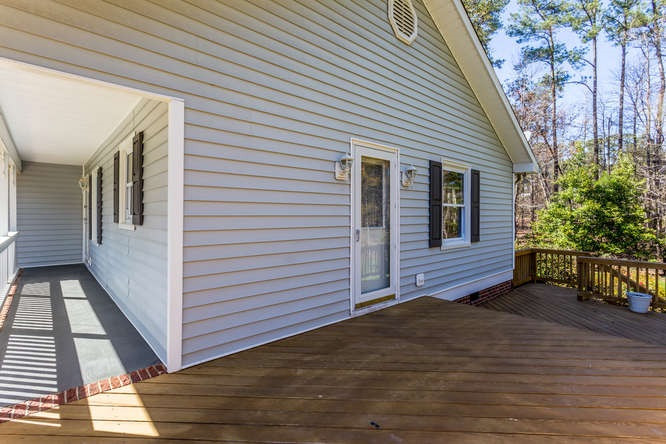 6916 Laurdane Road Raleigh, NC 27613 - Photo 18 of 23 Large Rocking Chair porch connects to the deck. Deck