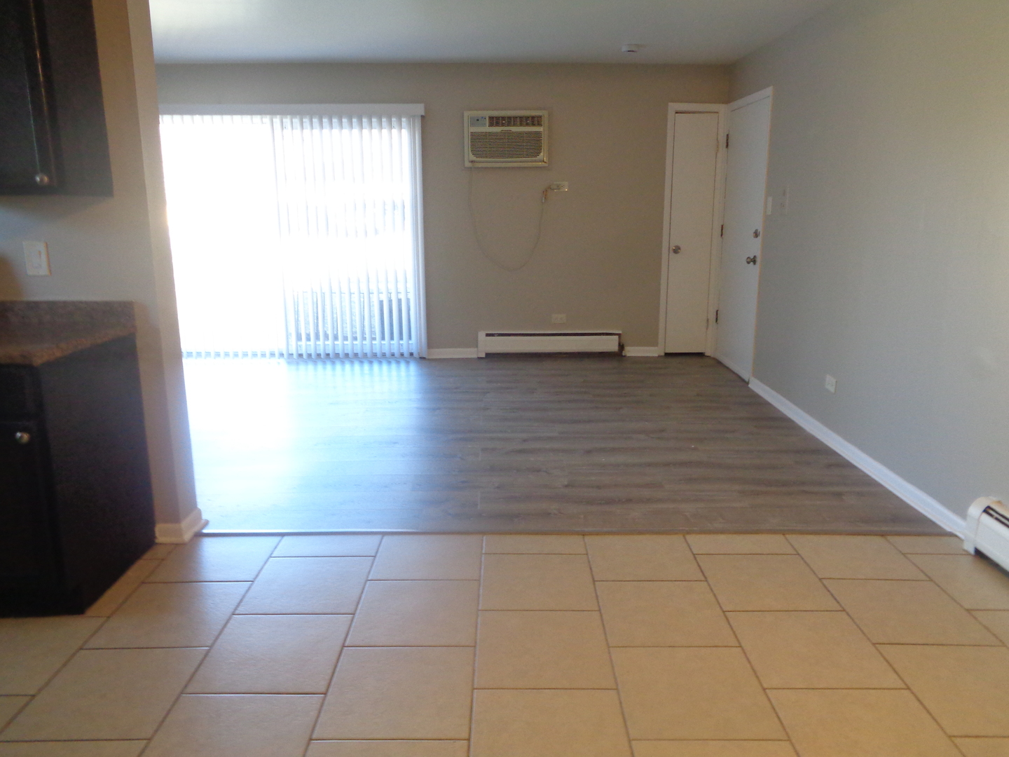8149 83rd Place, Unit 2 Justice, IL 60458 - Photo 4 of 10 an empty room with wooden floor and windows