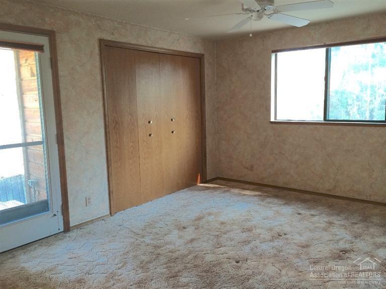1932 Northeast Wells Acres Road Bend, OR 97701 - Photo 5 of 7 master bedroom with ceiling fan & access