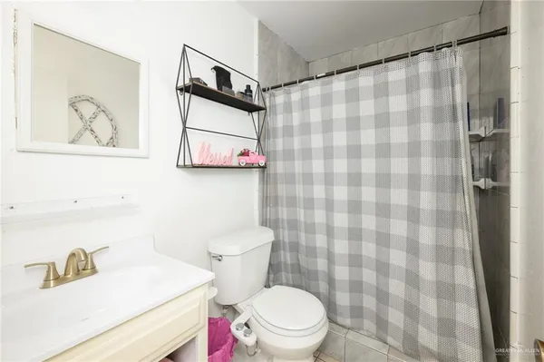 a white toilet sitting next to a bathroom sink