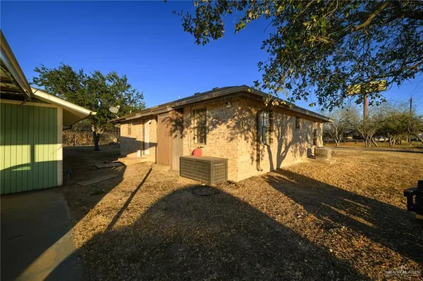 a view of a yard with yellow house