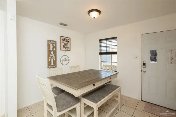 a view of a room that has a table and chairs in it