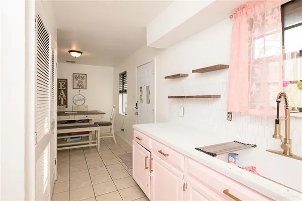 a kitchen that has a sink and a stove in it