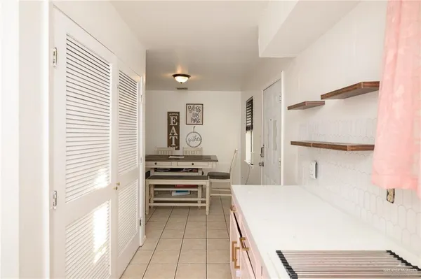 a kitchen with a refrigerator and white cabinets