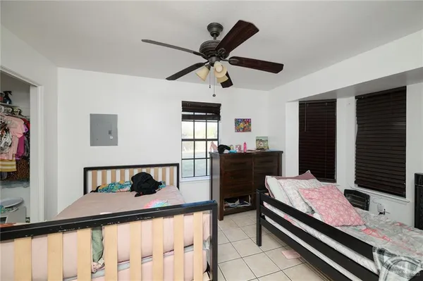 a living room with a bed furniture and a flat screen tv