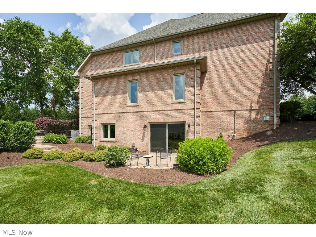 3735 Roberts Ridge Akron, OH 44333 - Photo 35 of 45 Side of property with a yard and a patio, lower level walk-out