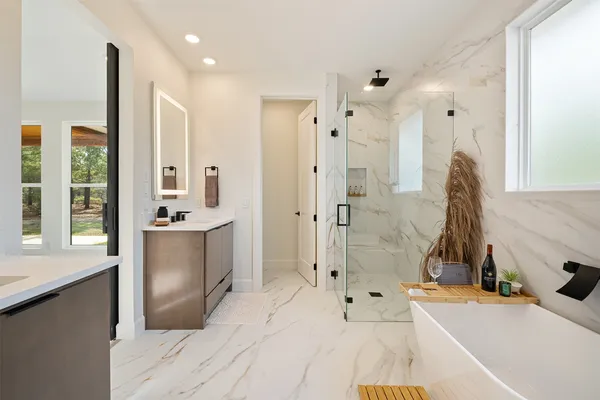 a bathroom with a tub sink and mirror