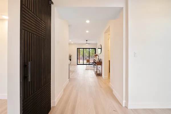 a view of hallway with wooden floor