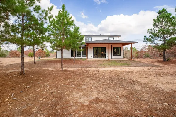 a front view of house with yard and trees