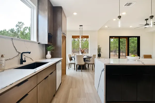 a kitchen with stainless steel appliances kitchen island granite countertop a sink and cabinets