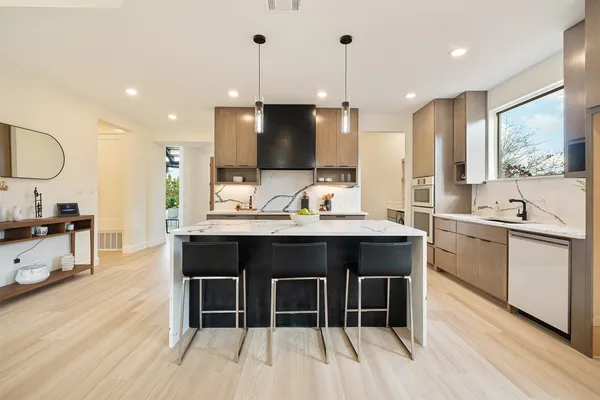 a kitchen with counter top space sink and center island