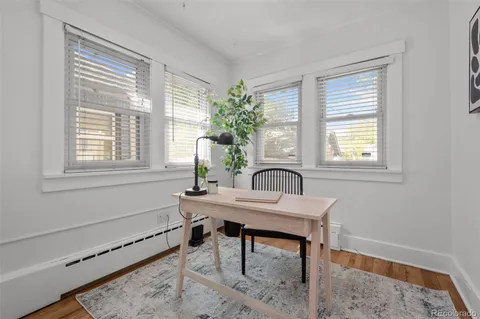a workspace with furniture window and wooden floor