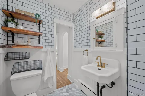 a bathroom with a toilet a sink and mirror