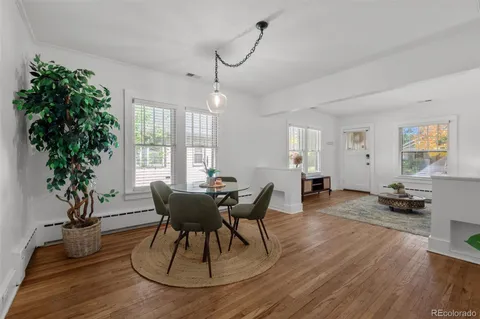 a view of a dining room with furniture window and wooden floor