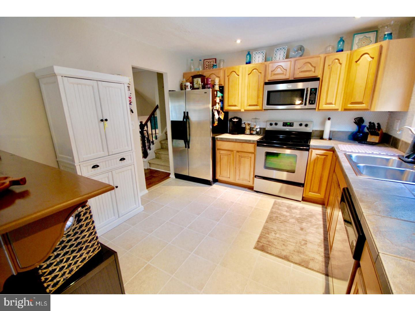 23 Orion Way Sewell, NJ 08080 - Photo 13 of 25 a kitchen with stainless steel appliances a stove a sink a microwave a refrigerator cabinets and a window