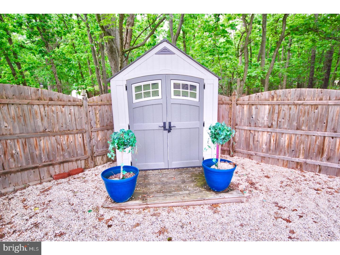 23 Orion Way Sewell, NJ 08080 - Photo 23 of 25 a view of a backyard with chair and potted plants