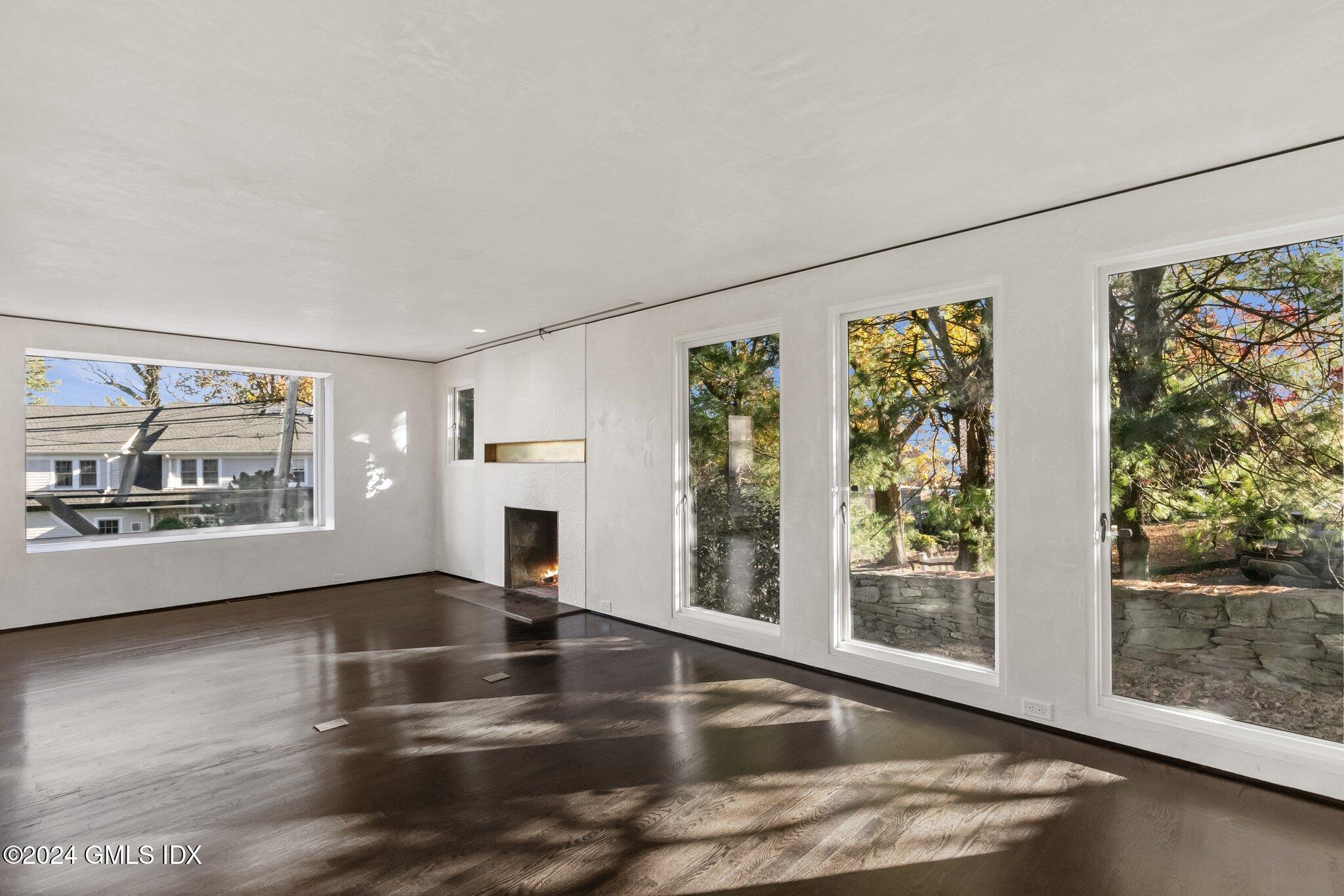 6 Marks Road Riverside, CT 06878 - Photo 5 of 19 a view of a livingroom with furniture wooden floor windows and garden view