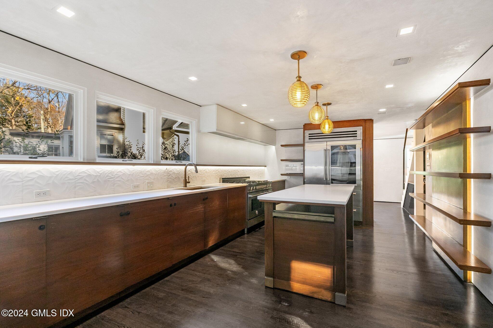 6 Marks Road Riverside, CT 06878 - Photo 6 of 19 a kitchen with stainless steel appliances granite countertop a sink a stove and a wooden floors
