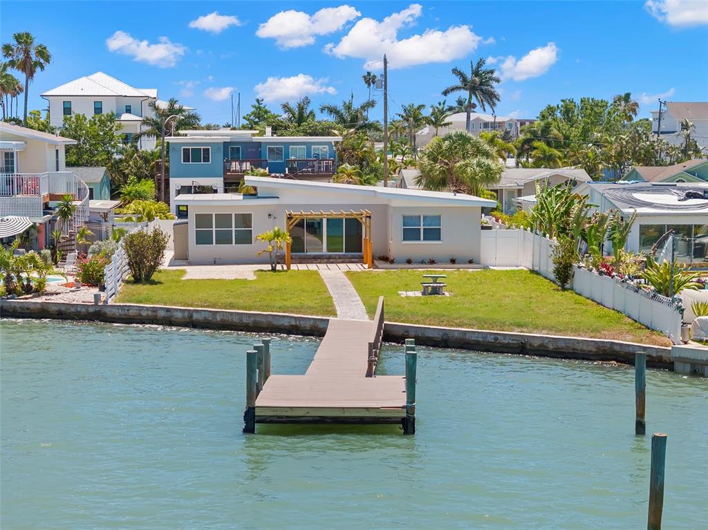 708 Sunset Cove Madeira Beach, FL 33708 - Photo 2 of 61 an aerial view of a house with swimming pool patio and outdoor seating