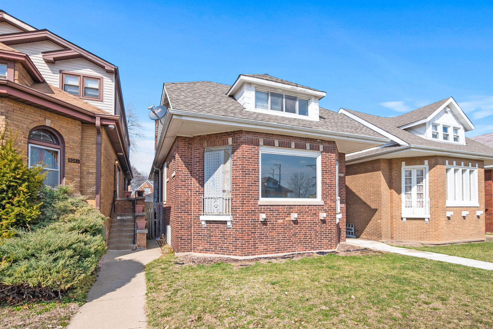 1040 West 92nd Place Chicago, IL 60620 - Photo 1 of 19 a front view of a house with a yard